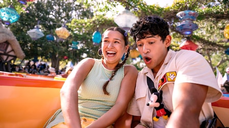 A boy and girl riding in a teacup on the Mad Tea Party at Disneyland Park
