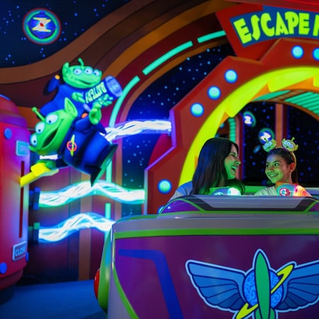 Guests smiling as they ride Buzz Lightyear's Space Ranger Spin at Magic Kingdom park
