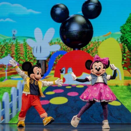 Mickey Mouse and Minnie Mouse dancing together on stage