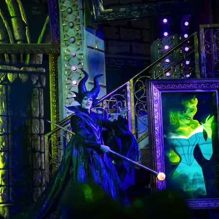 Maleficent on stage with an animated portrait of Aurora during Disney Villains, Unfairly Ever After at Disney’s Hollywood Studios