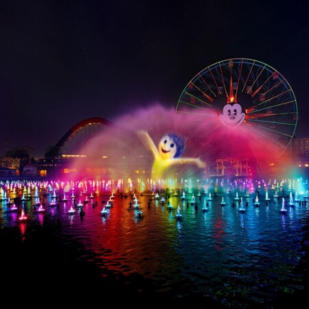 The character Joy projected on a wall of water during the World of Color Happiness nighttime spectacular