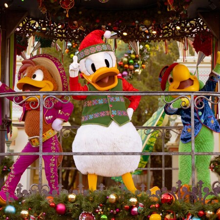 Donald Duck, Panchito Pistoles and José Carioca, dressed in holiday attire on a parade float during the Disney Viva Navidad celebration at Disney California Adventure Park