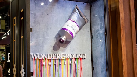A sign with a large bottle of paint and the words ‘Wonderground Gallery’