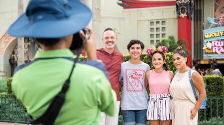 A Disney Cast Member taking a professional photo of a family