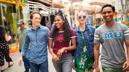 Two couples strolling through the Downtown Disney District