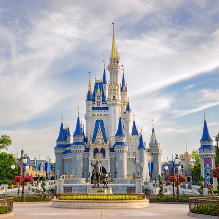 Cinderella Castle with a statue of Walt Disney and Mickey Mouse at Magic Kingdom park in Walt Disney World Resort