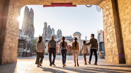 A family walking through an entryway leading into Star Wars Galaxy’s Edge