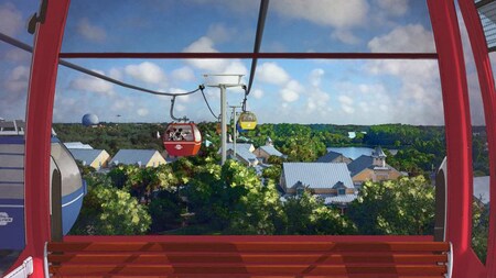 Disney Skyliner gondolas stretch over the tops of trees and buildings with Epcot in the background