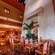 A restaurant dining area featuring high ceilings, plants and contemporary Mexican decor
