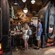 Two customers at the counter with two cast members behind the counter and two very large popcorn machines filled with Outpost Mix