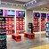 Interior of Fit2Run featuring sneaker wall displays, racks of running accessories, sitting benches, TV monitors and an area dedicated to an aetrex foot scanning device