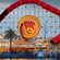 The round Pixar Pier sign at the center of Incredicoaster