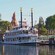 Water shimmers as a vintage paddlewheel riverboat waits at a dock for its next adventure.