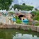 A Storybook Land Canal Boat full of Guests drifts gently past miniature villages