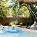 A dad and his 2 kids enjoy the water gushing from the 