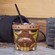 The Cool Headed Monkey cocktail, served in a monkey themed cup