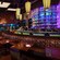 Banquette tables in front of semicircular bar and lit tequila display, across from an open kitchen