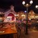 Bavaria-themed dining area in Biergarten Restaurant featuring long communal tables, street lamps and a stage