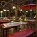 Lighted outdoor seating with rectangular and round tables with umbrella
