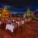 View of dining area with tile floors, tables and Mayan pyramid in background