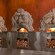 Three wood-fired ovens with comical faces whose mouths show the oven flames