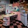 A pink-and-black kitchenette area with a 