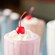 Strawberry, chocolate and vanilla shakes, each topped with whipped cream and a cherry 