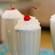 Milkshakes topped with whipped cream and cherries