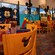 A section of the main dining area at Chef Mickey's, with a Mickey cartoon mural along the wall