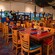 Main dining area at Chef Mickey's, with a Mickey cartoon mural along the wall