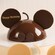 A chocolate cake designed to resemble Mickey Mouse, inscribed with the message 'Happy Birthday'