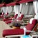 A row of lounge chairs and cabanas decorated with large flower planters at a Disney Resort hotel