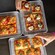 Hands reaching for 3 trays of square cut pizza with varied toppings