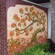 An outdoor mural of a whimsical tree full of oranges