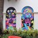 Two murals featuring abstract hands and geometric designs
