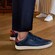 The feet of a man and a woman wearing Cole Haan sneakers