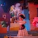 A Mexican girl doll with vases of paper cutout flowers around her at Gran Fiesta Tour Starring The Three Caballeros