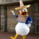 Donald Duck wearing a poncho and sombrero in front of stone sculptures at the Mexico Pavilion in Epcot
