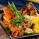 Chicken topped with seasonal vegetables, plated with macaroni and cheese, Nørwegian meatballs with lingonberry jam, mashed potatoes, roasted and grilled salmon from Akershus Royal Banquet Hall
