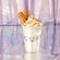 A vanilla shake with caramel sauce and a topping of 2 churro pieces