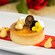Crème Brûlée topped with edible flowers and a chocolate medallion with a rose on it from Be Our Guest