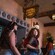Adults in Mickey Ear headbands socialize beneath the sign for The Beak and Barrel at Magic Kingdom park
