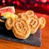 Two Mickey Mouse shaped waffles next to a bowl of fresh fruit, at Chef Mickey’s
