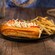 A lobster roll plated next to a pile of French fries