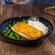 Maple mustard glazed salmon on top of rice and green beans in a bowl