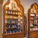 Three wooden display shelves holding fragrances and personal care items inside of Il Bel Cristallo at Epcot