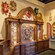 A section of Il Bel Cristallo at Epcot with carved wooden cabinets displaying Venetian carnival masks