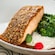 An almond crusted salmon filet paired with broccolini, celery root tapioca and adobo sauce