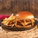 A cheeseburger with 2 beef patties, cheese, bacon and a side of fries