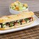 Chicken Caprese Baguette Sandwich with pesto and balsamic drizzle alongside a Caesar Salad